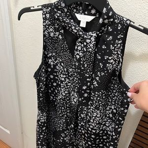 Sleeveless tunic with elegant neckline accent.